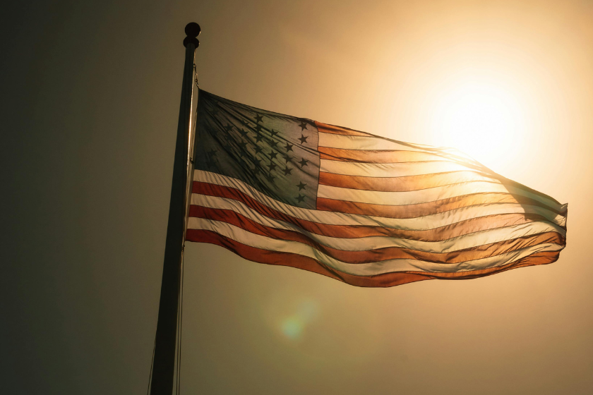 United States flag in front of hot sun