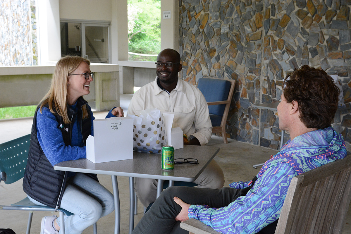 Sally Jernigan-Smith (MEM ’24) and Lambert Ngenzi (MEM ’23) talk with Jonathan Phillips, director of the James E. Rogers Energy Access Project at Duke, during a lunch celebrating the Nicholas Institute's 2022-2023 student assistants.