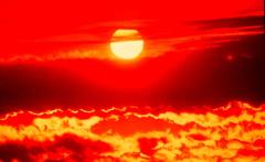 Red sky sunset, full sun in clouds