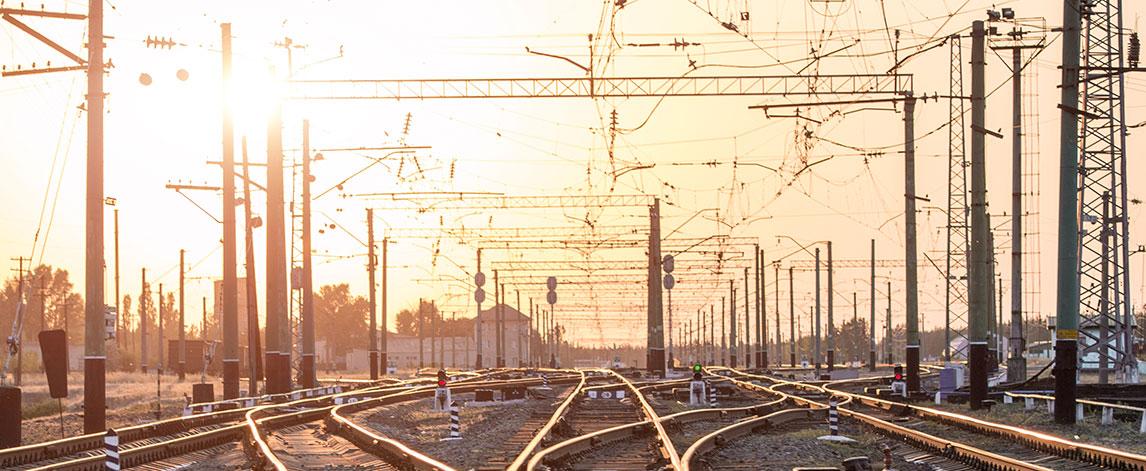 An empty railway sorting station or terminal with lots of junctions. Bright sunlight in background