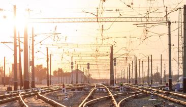 An empty railway sorting station or terminal with lots of junctions. Bright sunlight in background