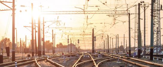 An empty railway sorting station or terminal with lots of junctions. Bright sunlight in background